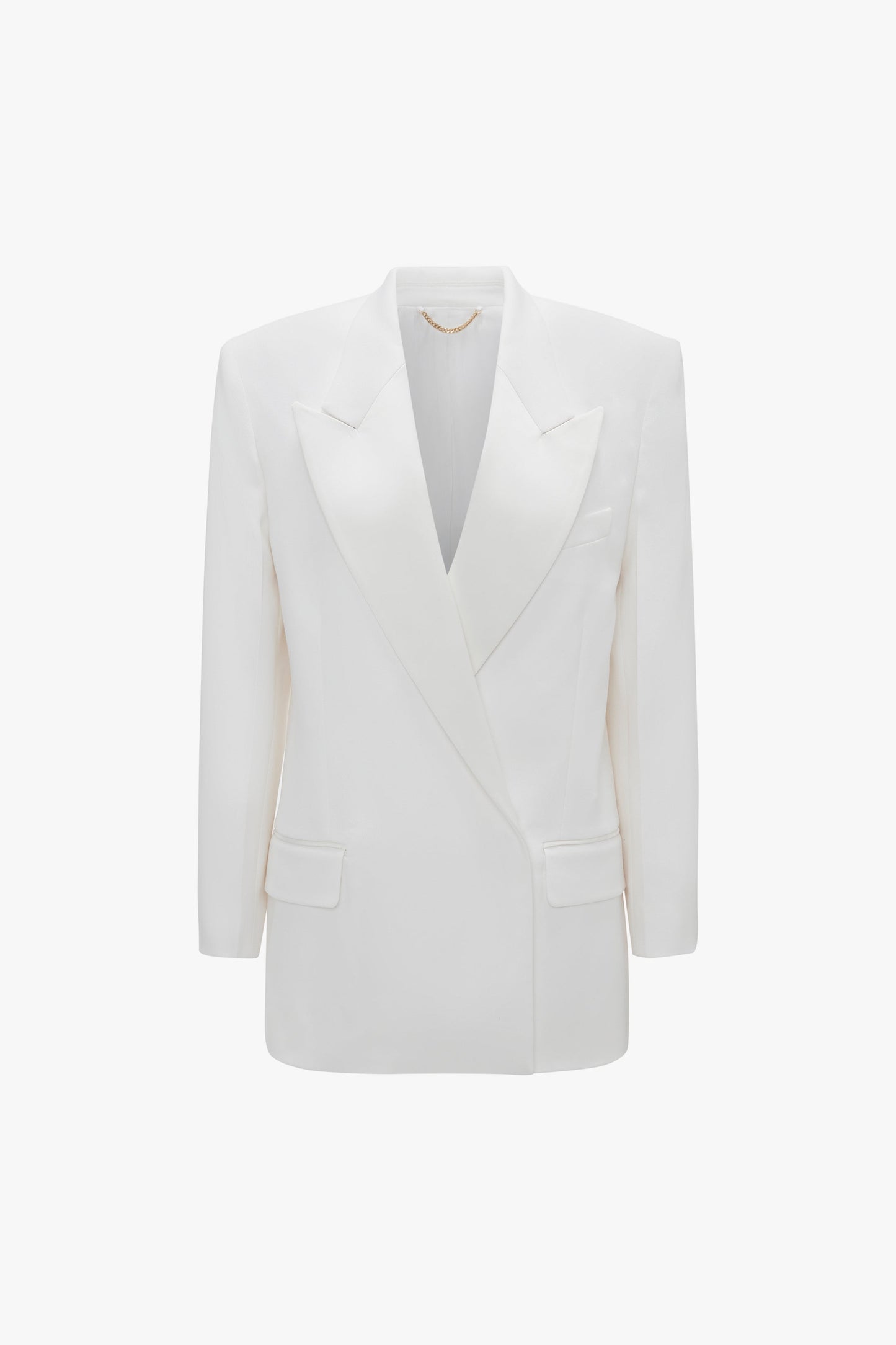 A white, double-breasted blazer with satin peak lapels, front flap pockets, and a structured silhouette. The Exclusive Double Breasted Tuxedo Jacket In Ivory by Victoria Beckham brings a tuxedo style elegance to your ensemble.