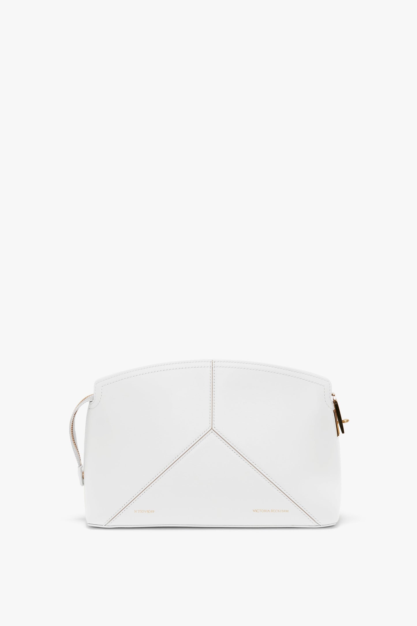 An **Exclusive Victoria Clutch Bag In White Leather** with geometric stitching, gold zipper, and minimal branding showcases a structured design in true **Victoria Beckham** fashion.