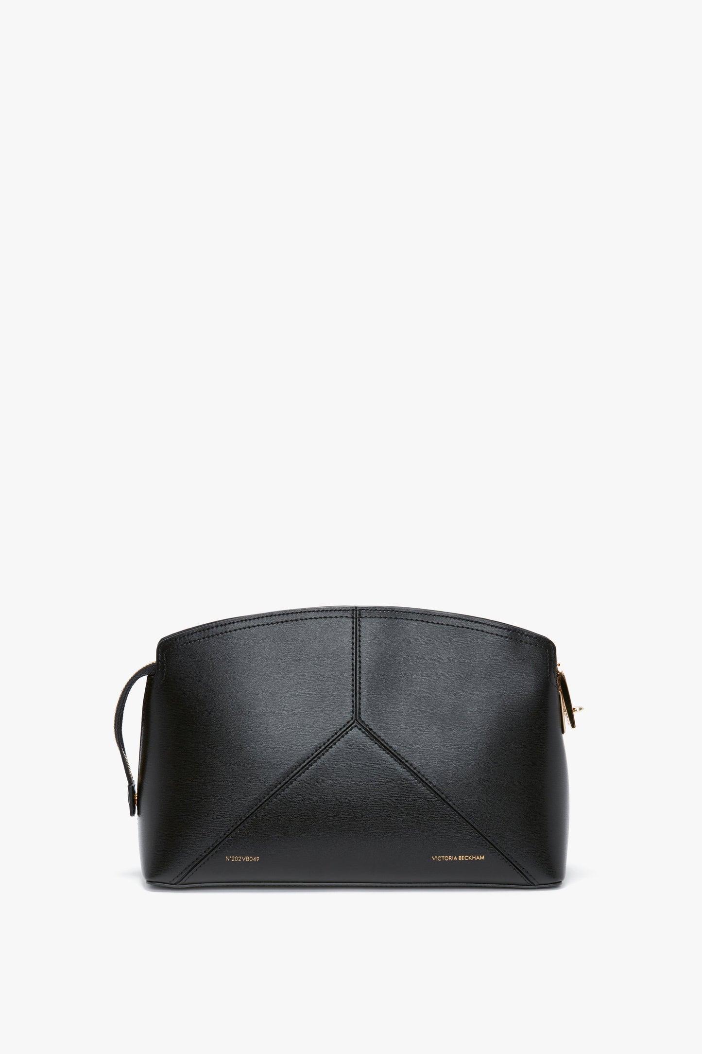 A Victoria Beckham Victoria Clutch Bag In Black Leather with a unique geometric design on the front, small gold text at the bottom, and a structured silhouette reminiscent of Victoria Beckham leather goods.
