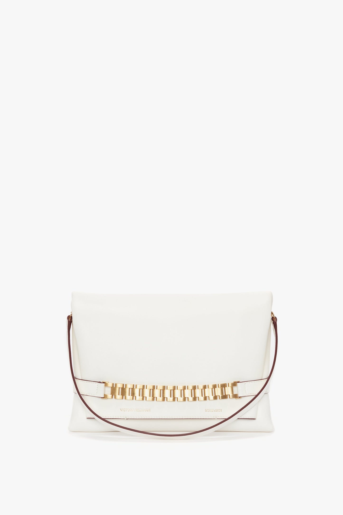 A white **Chain Pouch Bag With Strap In White Leather** crafted from tactile Nappa leather, featuring a gold-tone rectangular link chain accent and a thin brown detachable shoulder strap by **Victoria Beckham**.