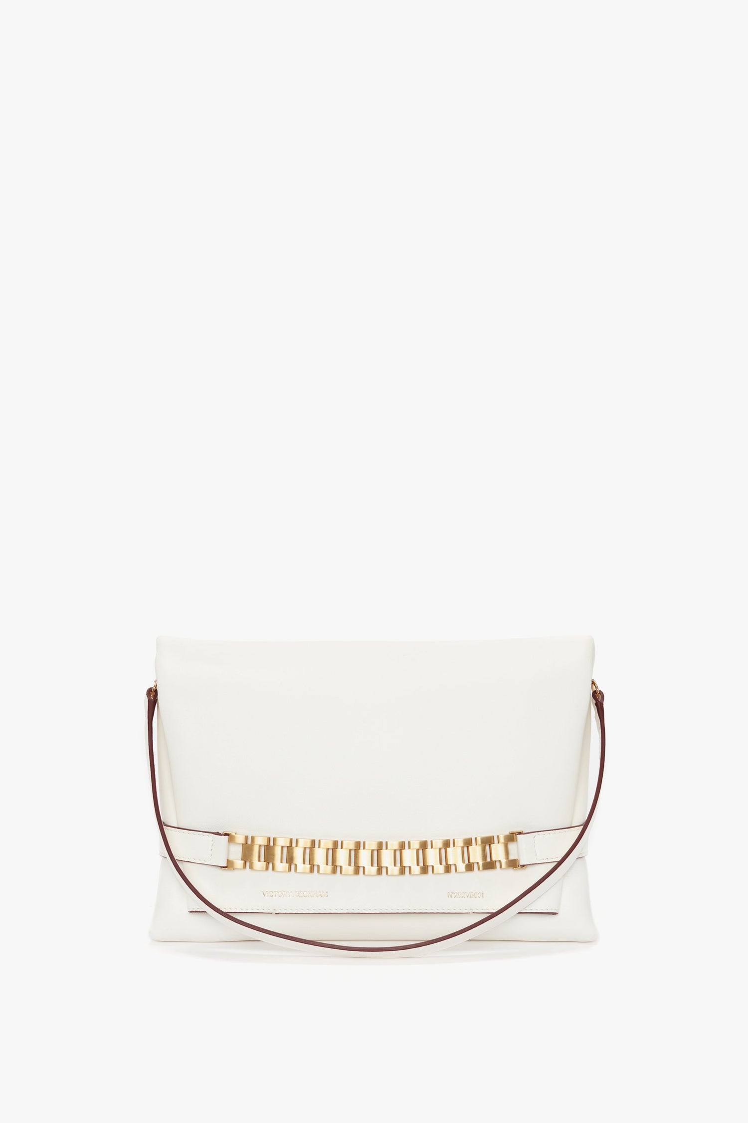 A white **Chain Pouch Bag With Strap In White Leather** crafted from tactile Nappa leather, featuring a gold-tone rectangular link chain accent and a thin brown detachable shoulder strap by **Victoria Beckham**.