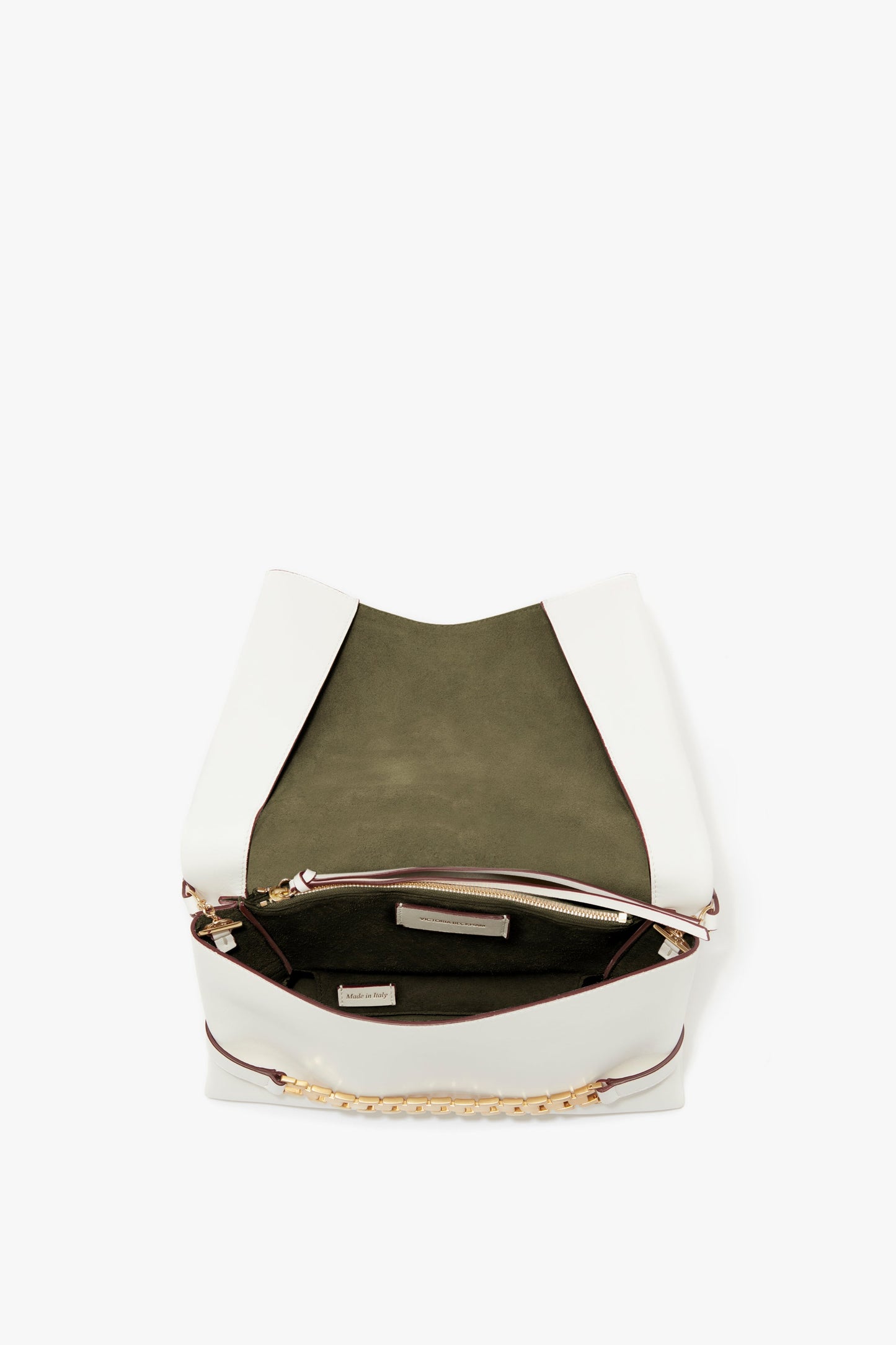 Open Chain Pouch Bag With Strap In White Leather by Victoria Beckham with olive green interior lining, featuring a small inner zipped pocket and gold-tone chain detail. Crafted from tactile Nappa leather, it includes a detachable strap for versatile wear.