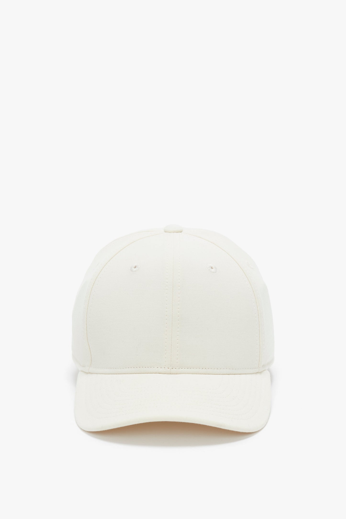 Front view of a plain beige Logo Cap In Antique White by Victoria Beckham against a white background.