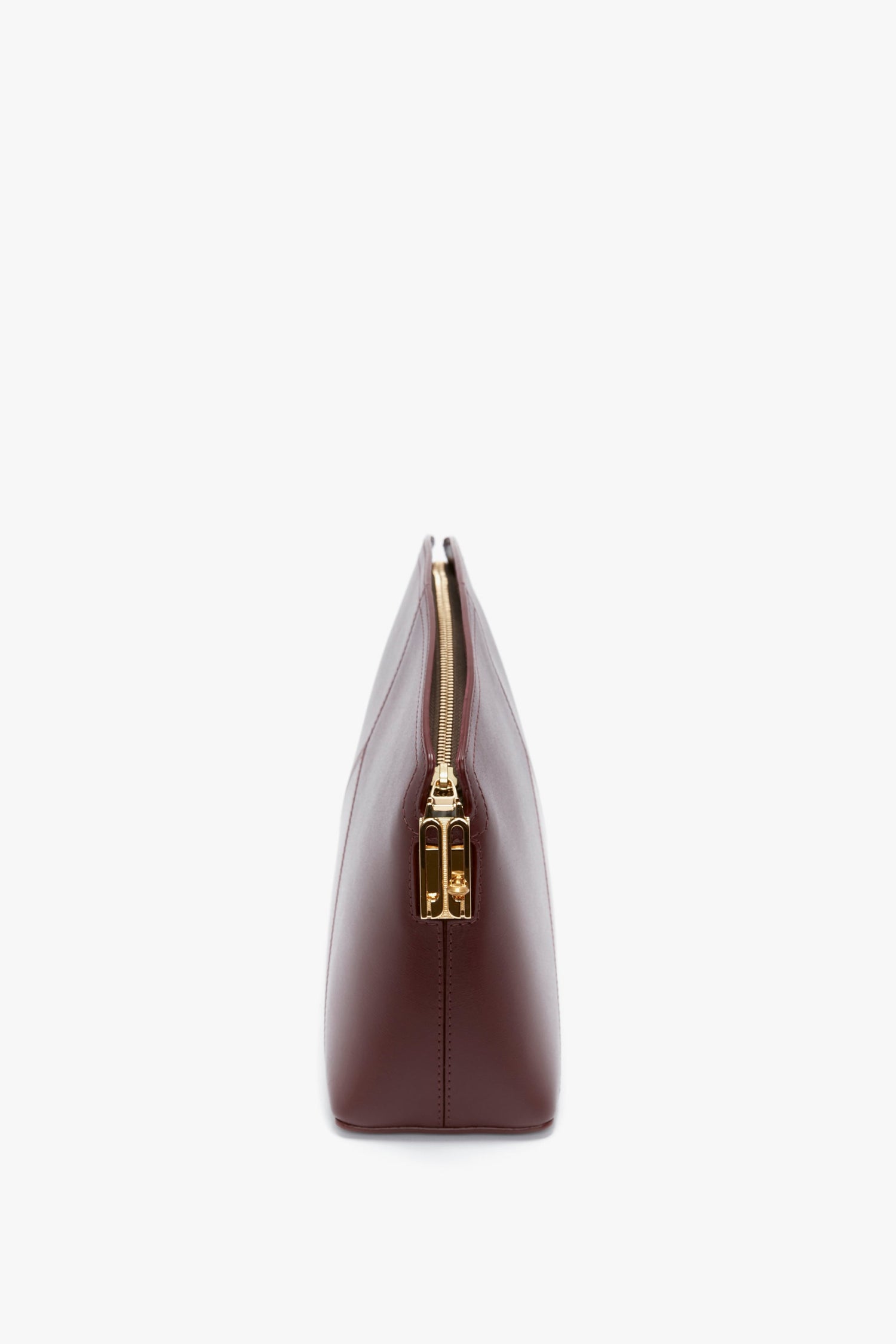 Side view of a closed Victoria Clutch Bag In Burgundy Leather by Victoria Beckham, set against a white background.