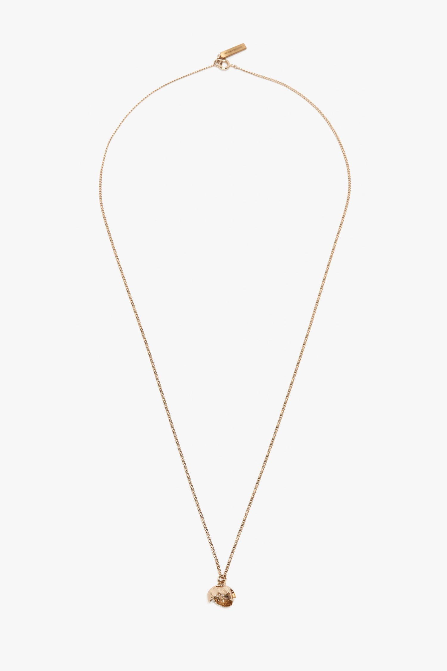 A gold chain necklace featuring a small, intricately detailed Camellia Flower pendant, handcrafted in Italy and displayed against a plain white background is replaced with the Exclusive Camellia Flower Necklace In Gold by Victoria Beckham.