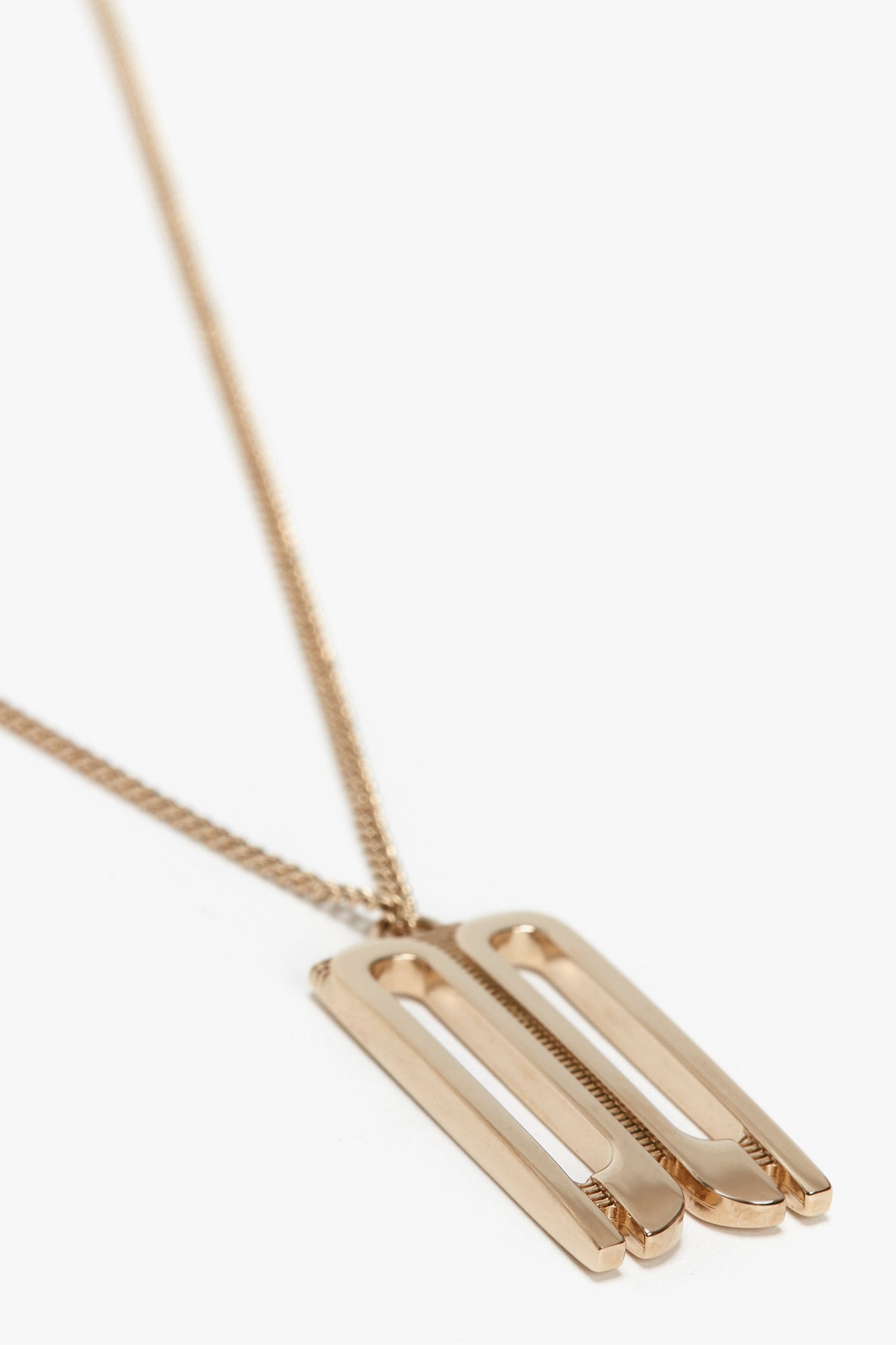 An Exclusive Frame Necklace In Gold with a double rectangular bar design on a thin chain, perfect for fans of Victoria Beckham accessories.