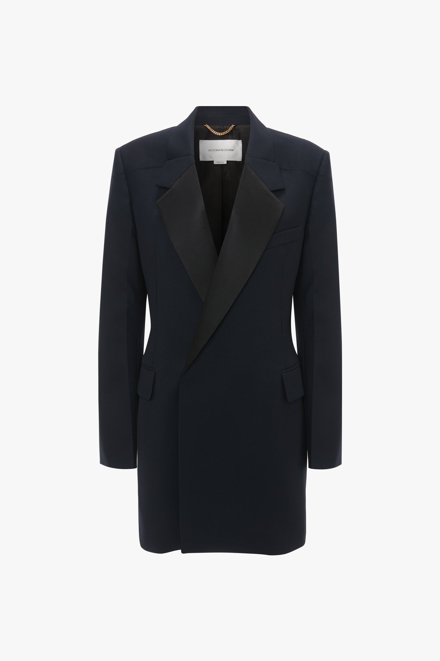 An Exclusive Fold Shoulder Detail Dress In Midnight by Victoria Beckham with a structured shoulder design, angled lapels, and flap pockets features a striking double-breasted cut against a white background.