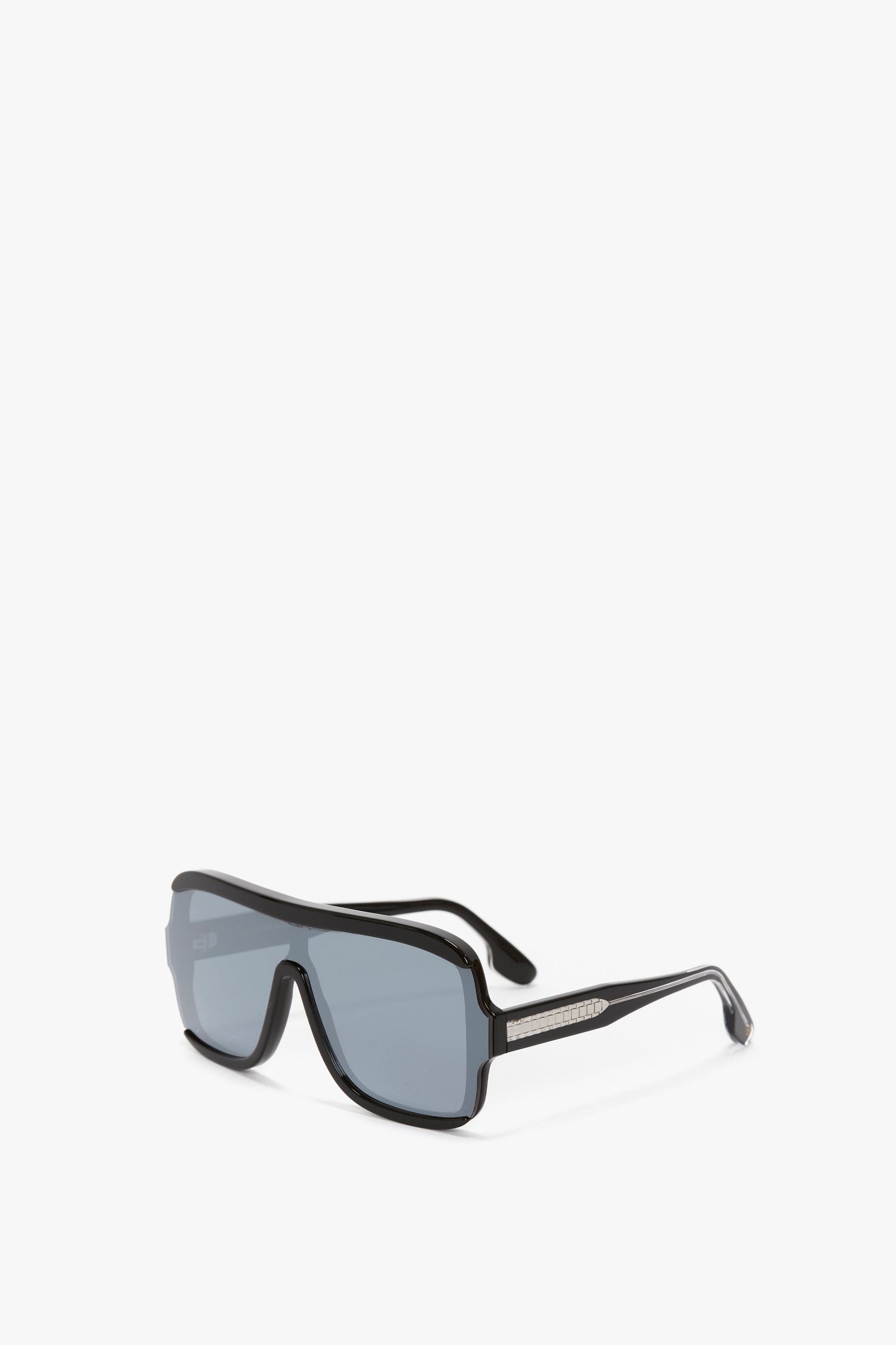 Layered Mask Sunglasses In Black-Silver-Mirror by Victoria Beckham with dark lenses and acetate temples, featuring a metallic logo detail on the arms. The sleek design is complemented by a guilloch pattern, set against a plain white background.