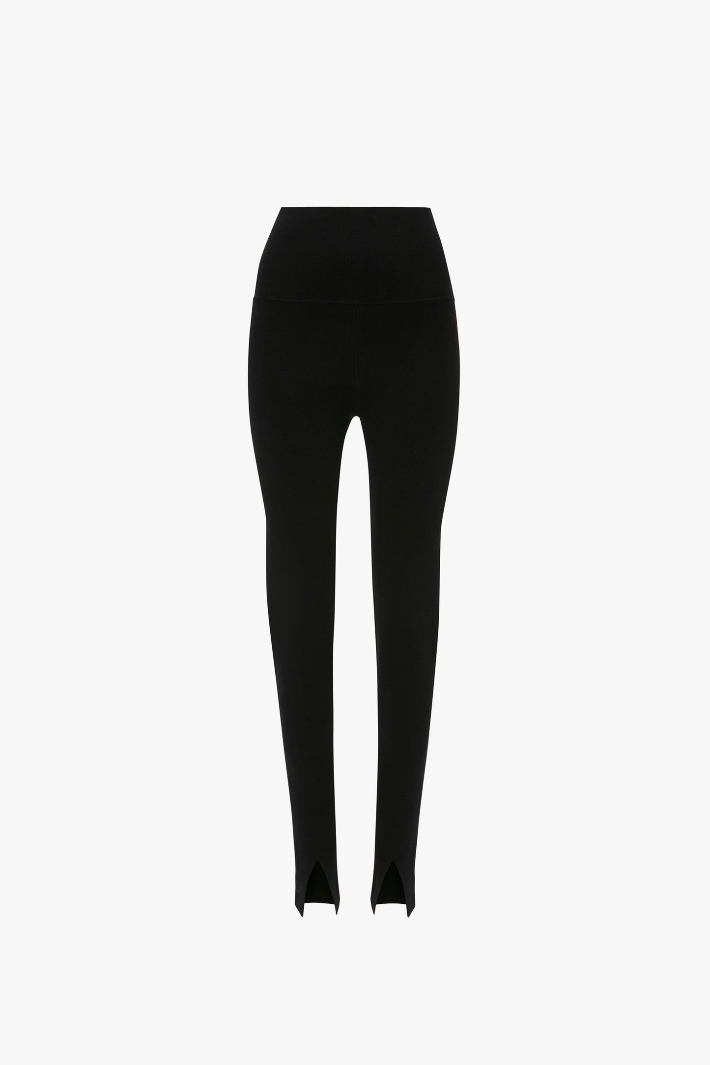 Image of a pair of black high-waisted leggings with stirrup foot straps, showcasing knitwear fabrication and a versatile silhouette. The leggings, reminiscent of the VB Body Split Front Leggings In Black by Victoria Beckham, are displayed against a plain white background.