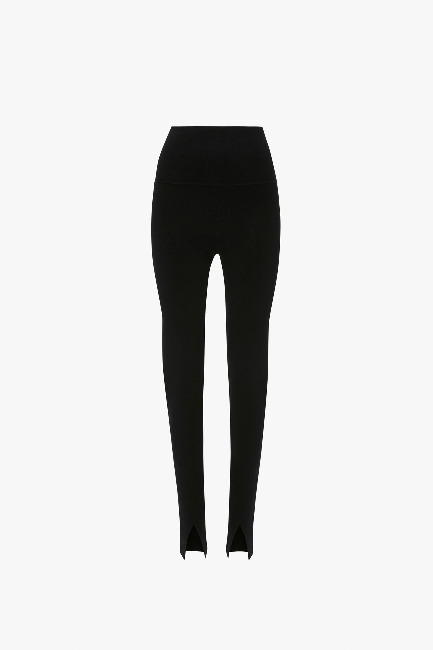 Image of a pair of black high-waisted leggings with stirrup foot straps, showcasing knitwear fabrication and a versatile silhouette. The leggings, reminiscent of the VB Body Split Front Leggings In Black by Victoria Beckham, are displayed against a plain white background.